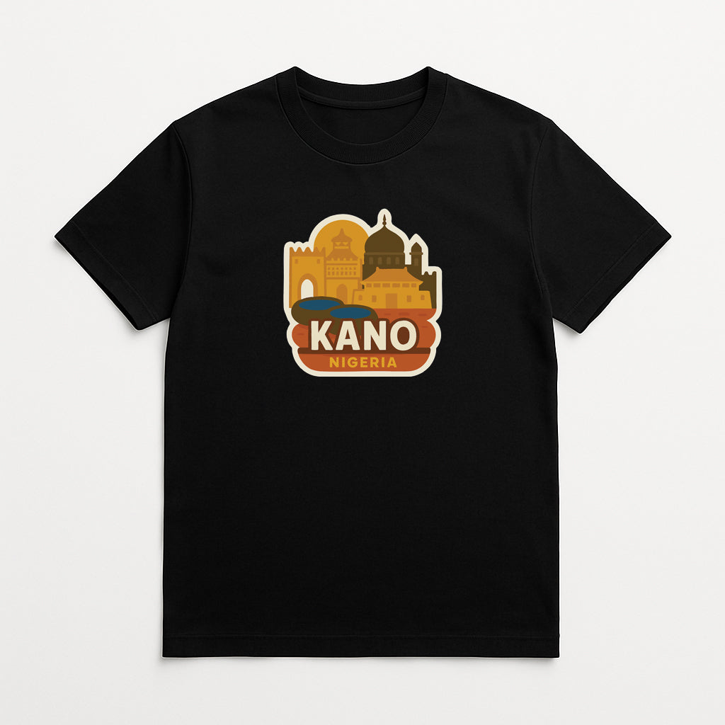 A black t-shirt with a graphic design featuring a stylized illustration of a city skyline, along with the text "KANO NIGERIA" prominently displayed.