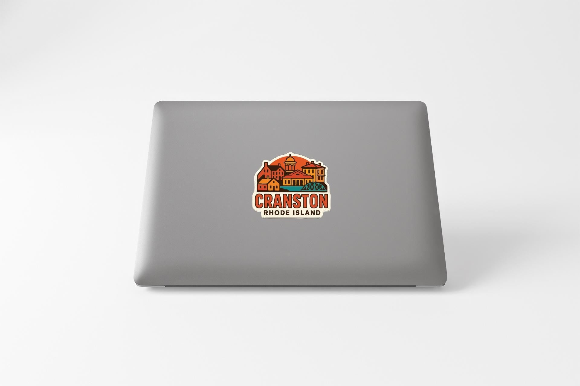 A sticker on the back of a laptop, featuring an illustration of Cranston, Rhode Island.
